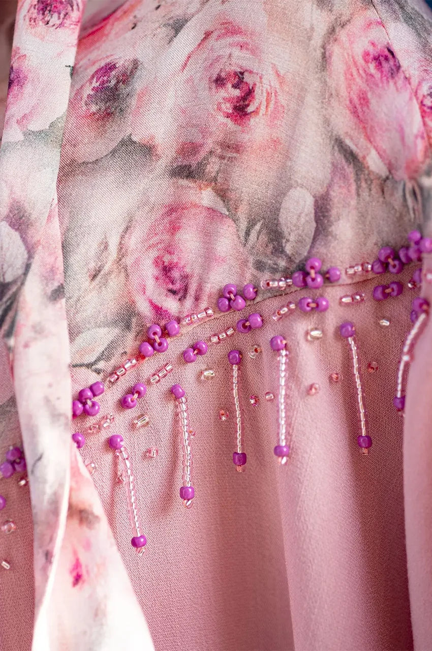 Detailed view of hand-applied beadwork on Selena pink beaded kaftan