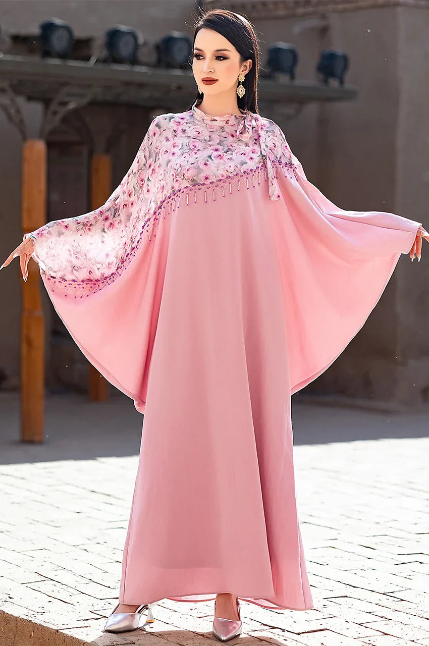 Full-length outdoor shot of Selena pink beaded kaftan with open cape sleeves