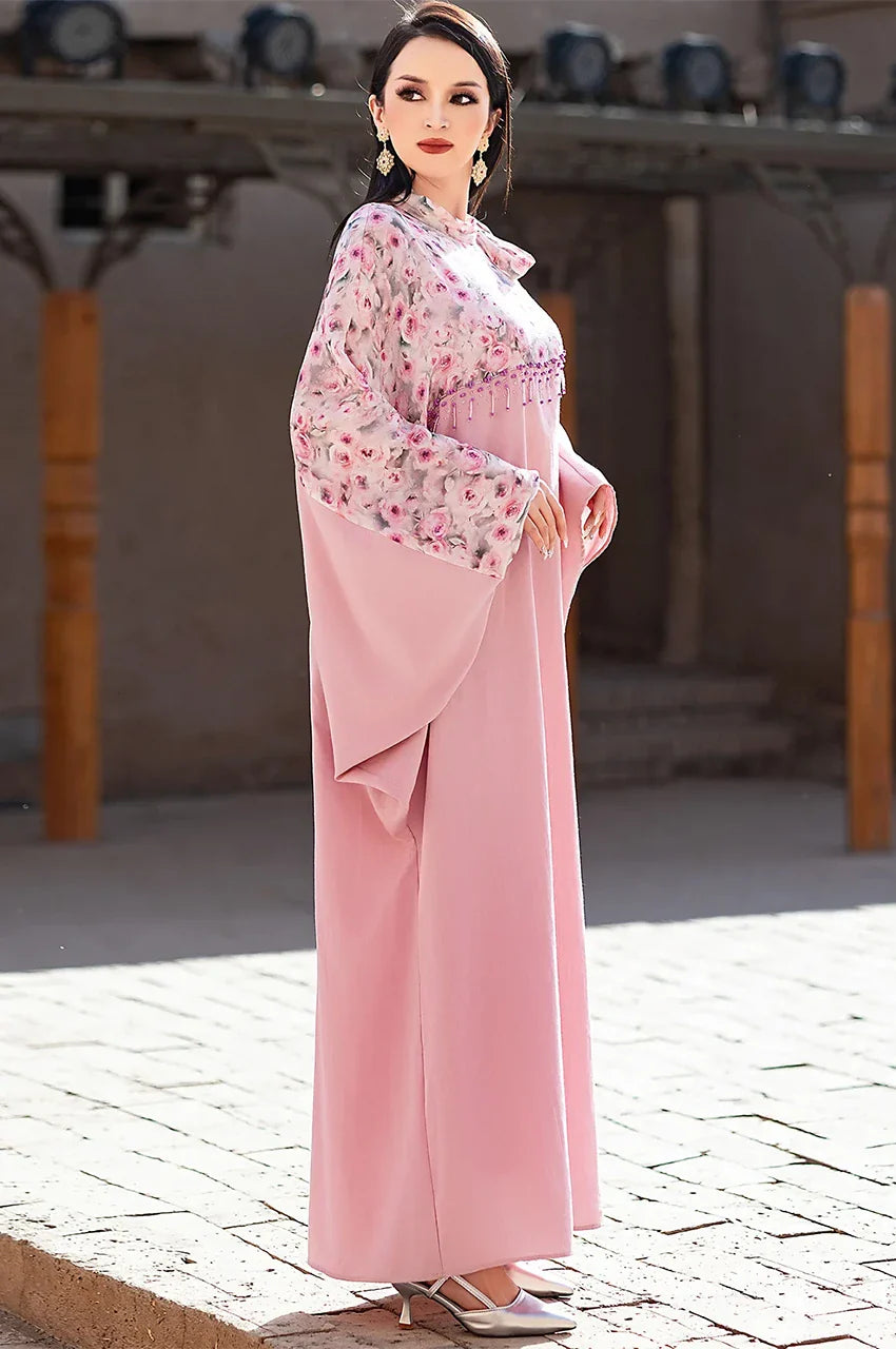 Side outdoor view of Selena pink beaded kaftan with flowing silhouette