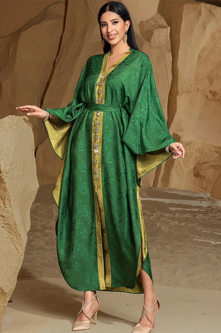 Relaxed front pose highlighting belt and drape of Selora green kaftan