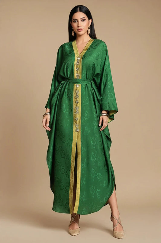 Portrait front view of Selora green embellished silk kaftan with gold-trimmed neckline and waist belt