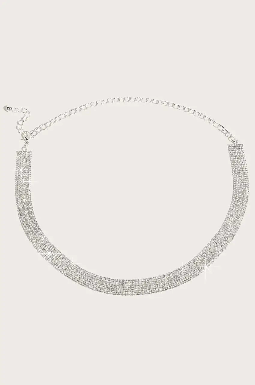 Flat lay view of silver rhinestone mesh belt showing wide crystal band and chain.