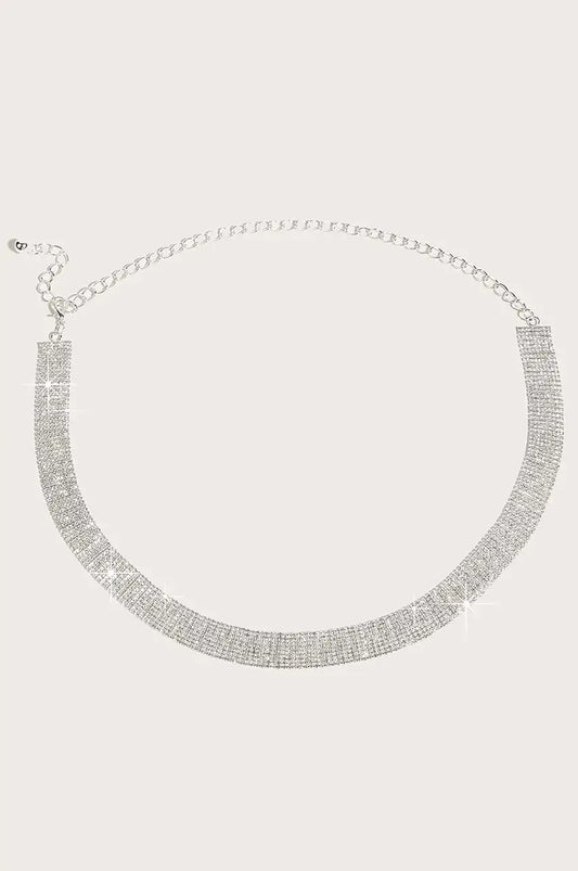Flat lay view of silver rhinestone mesh belt showing wide crystal band and chain.