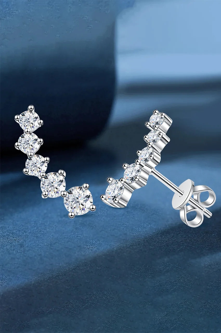 Side profile of crystal ear crawlers showing prong setting and butterfly back closure.