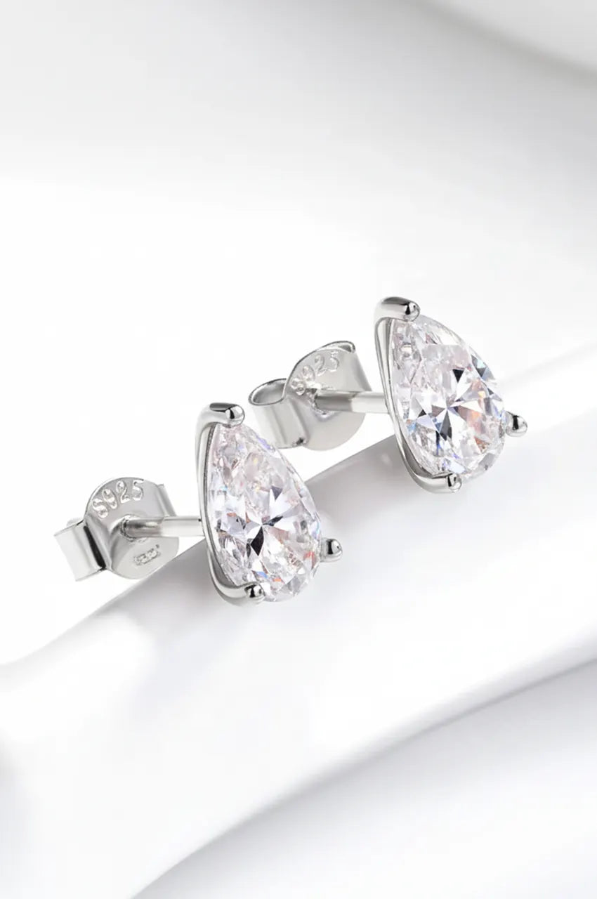 Side profile of silver teardrop studs showing the 3-prong setting height.