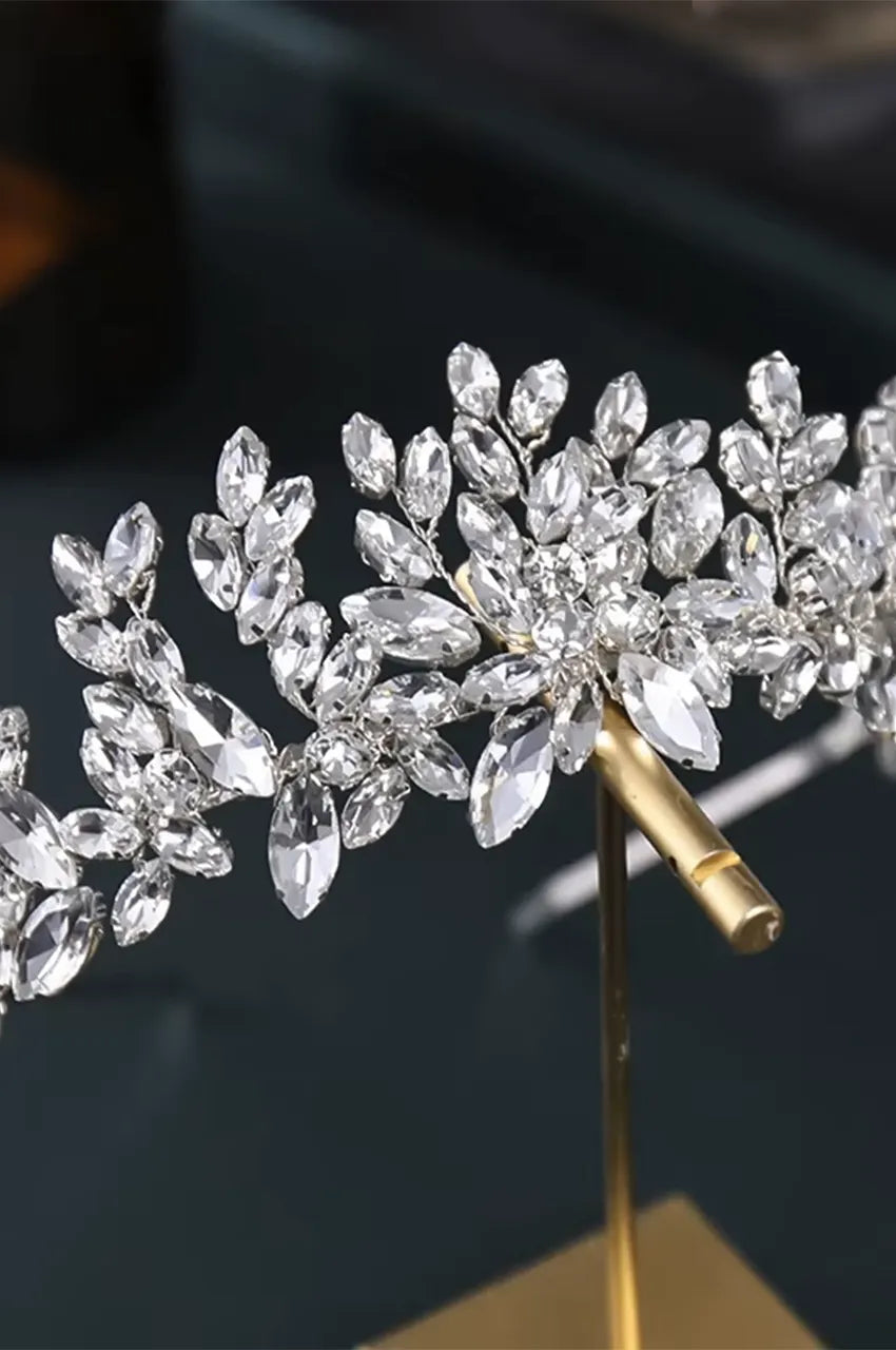 Angled top view of silver floral hair jewelry showcasing light reflection and structure.