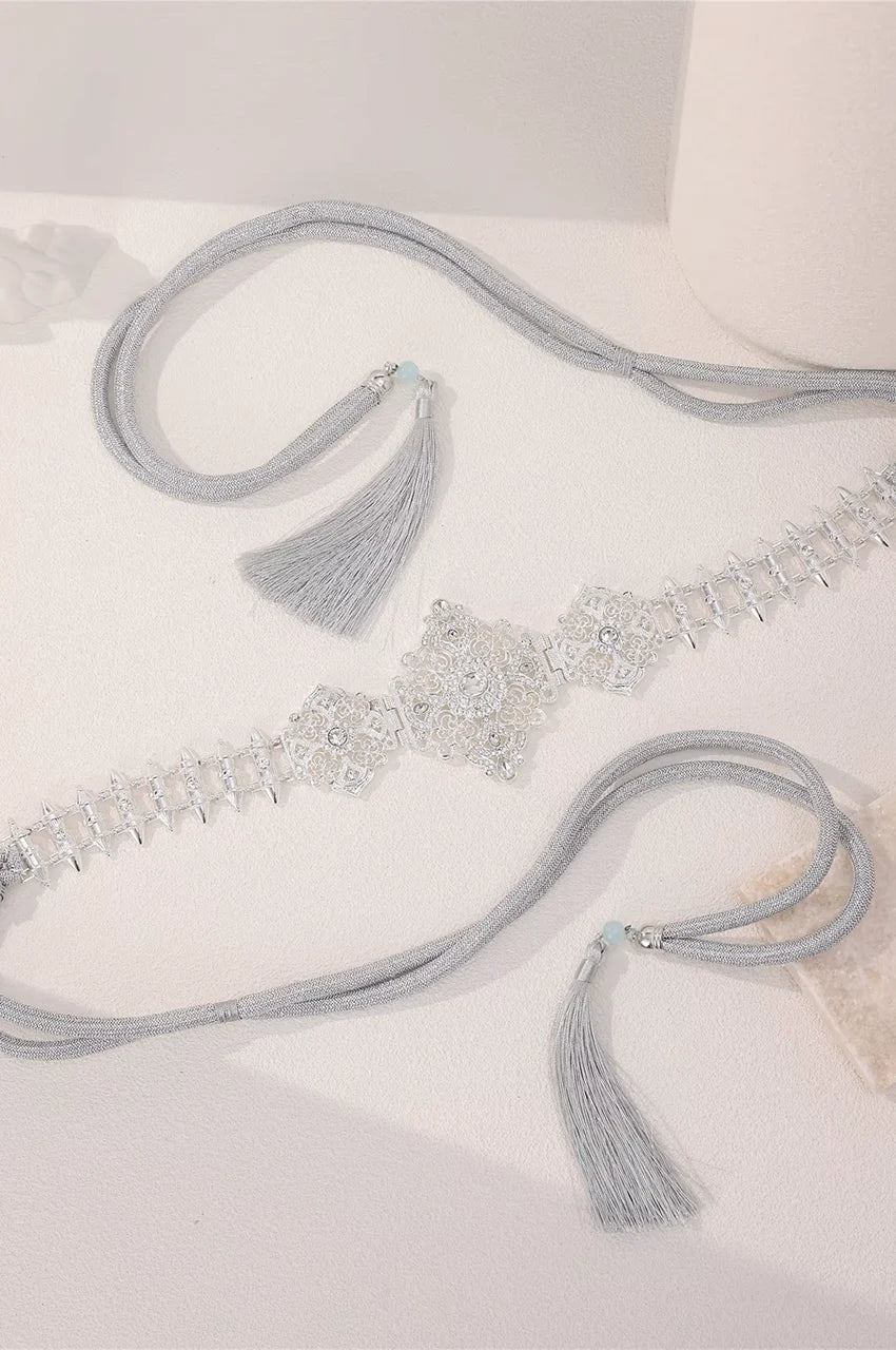 Flat lay display of the Silver Geometric Spike Link Belt showing crystal details and flexible cord.