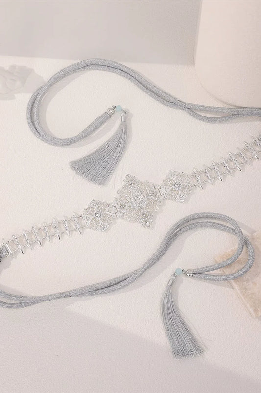 Flat lay display of the Silver Geometric Spike Link Belt showing crystal details and flexible cord.