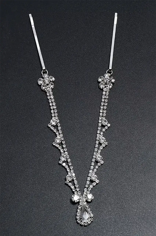 Silver rhinestone headpiece displayed on a black background, emphasizing the V-shape and crystal detail.
