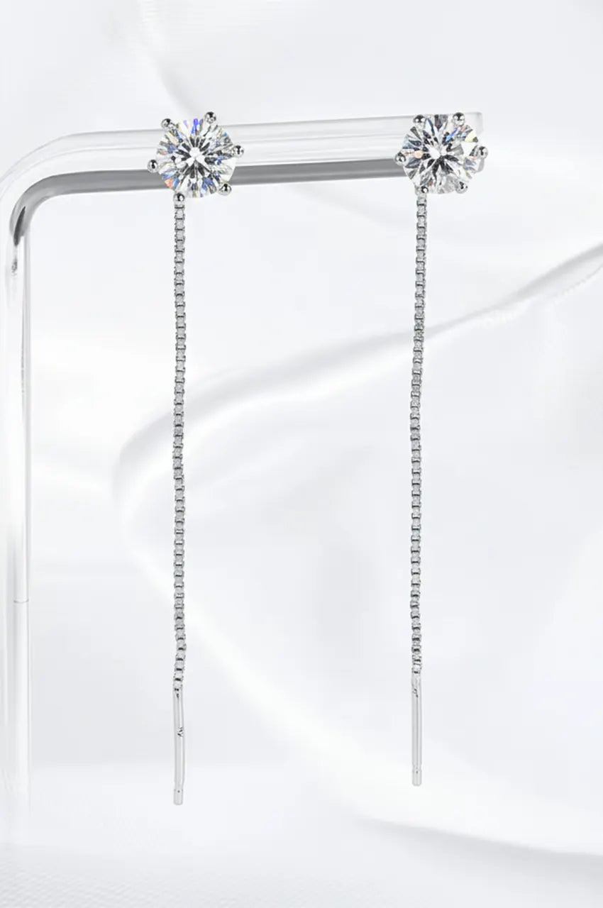 Silver S925 box chain threader earrings with round cut moissanite hanging on a clear display stand.