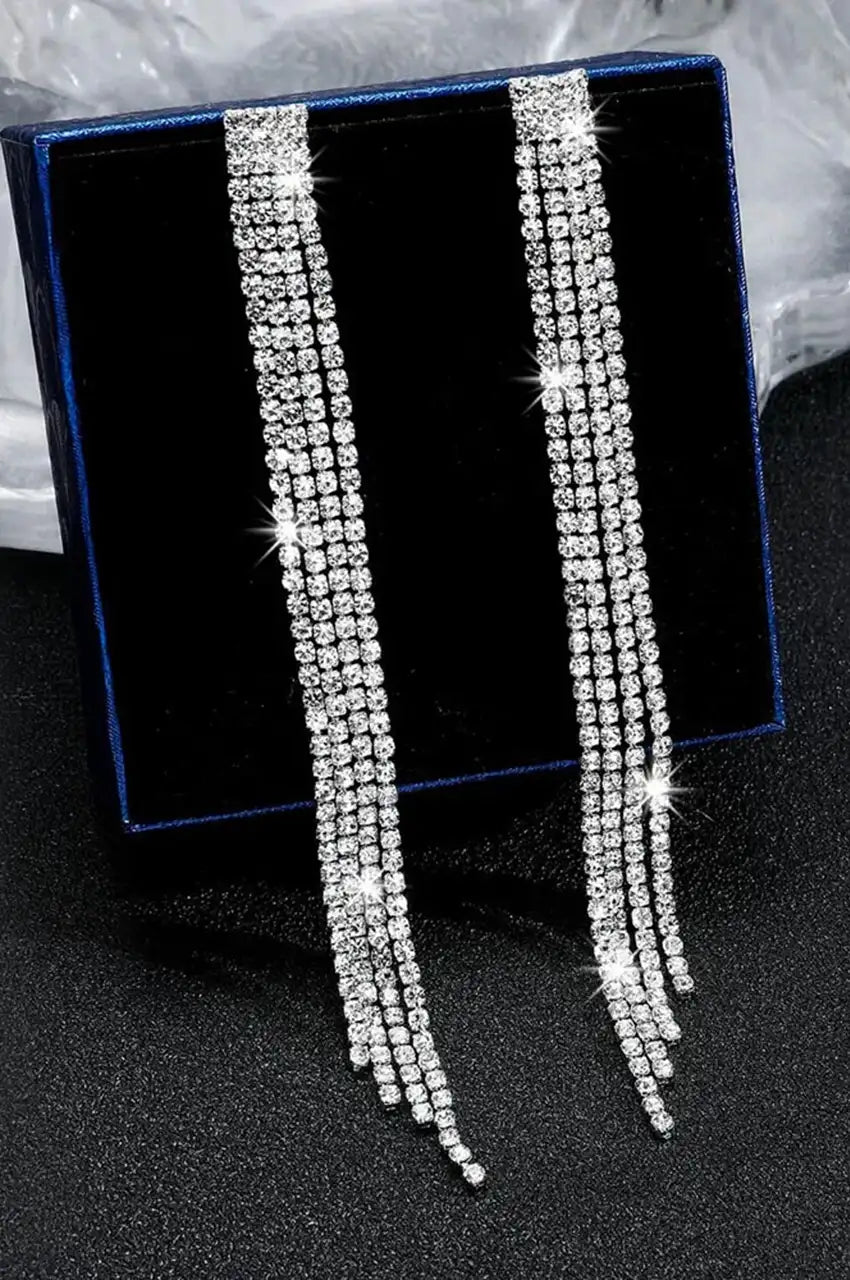 Silver waterfall drop earrings displayed in a blue jewelry gift box.