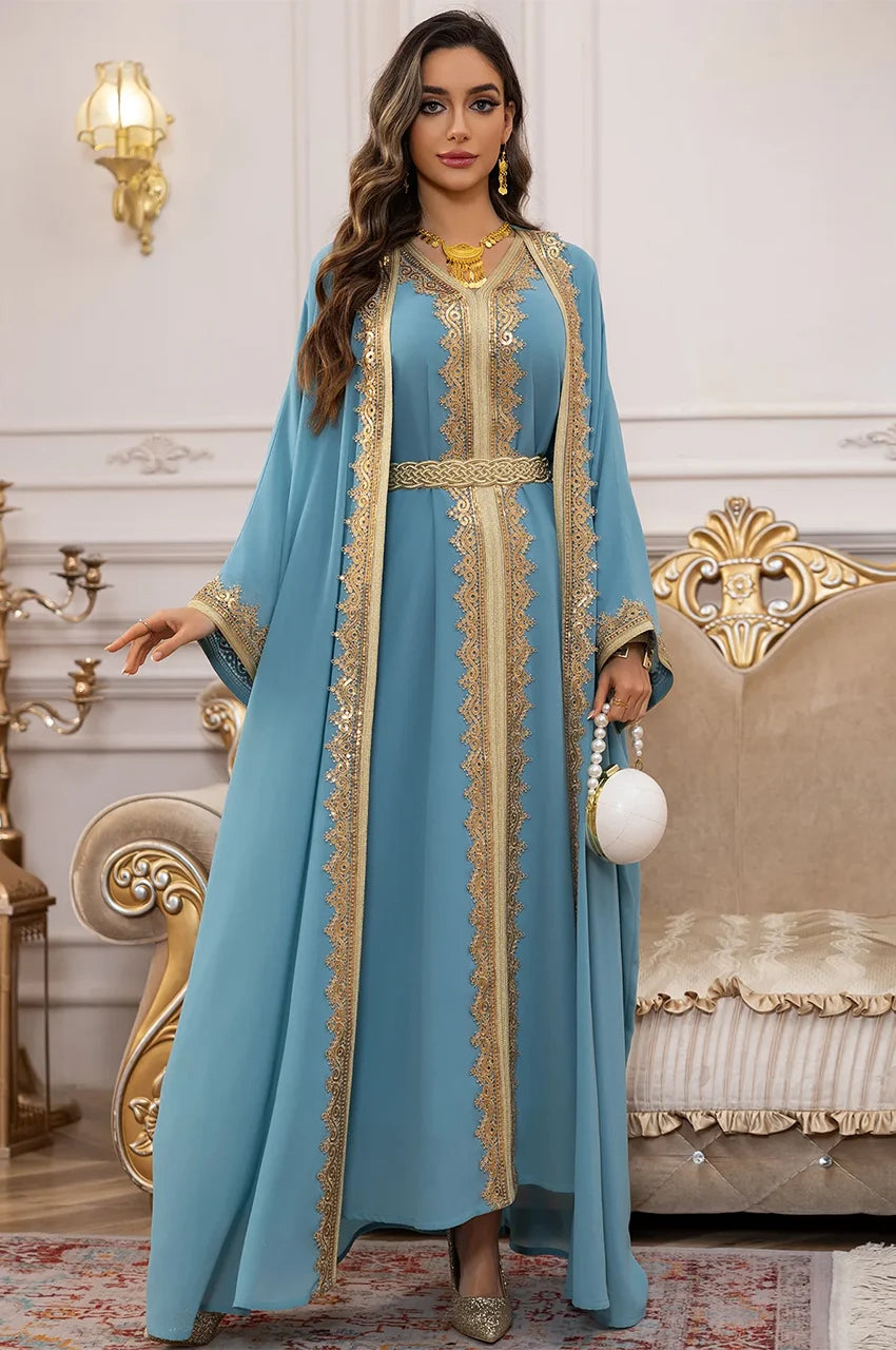 Lifestyle shot of the NAYRA sky blue 2-piece long sheer kaftan with gold embroidery and accessories.