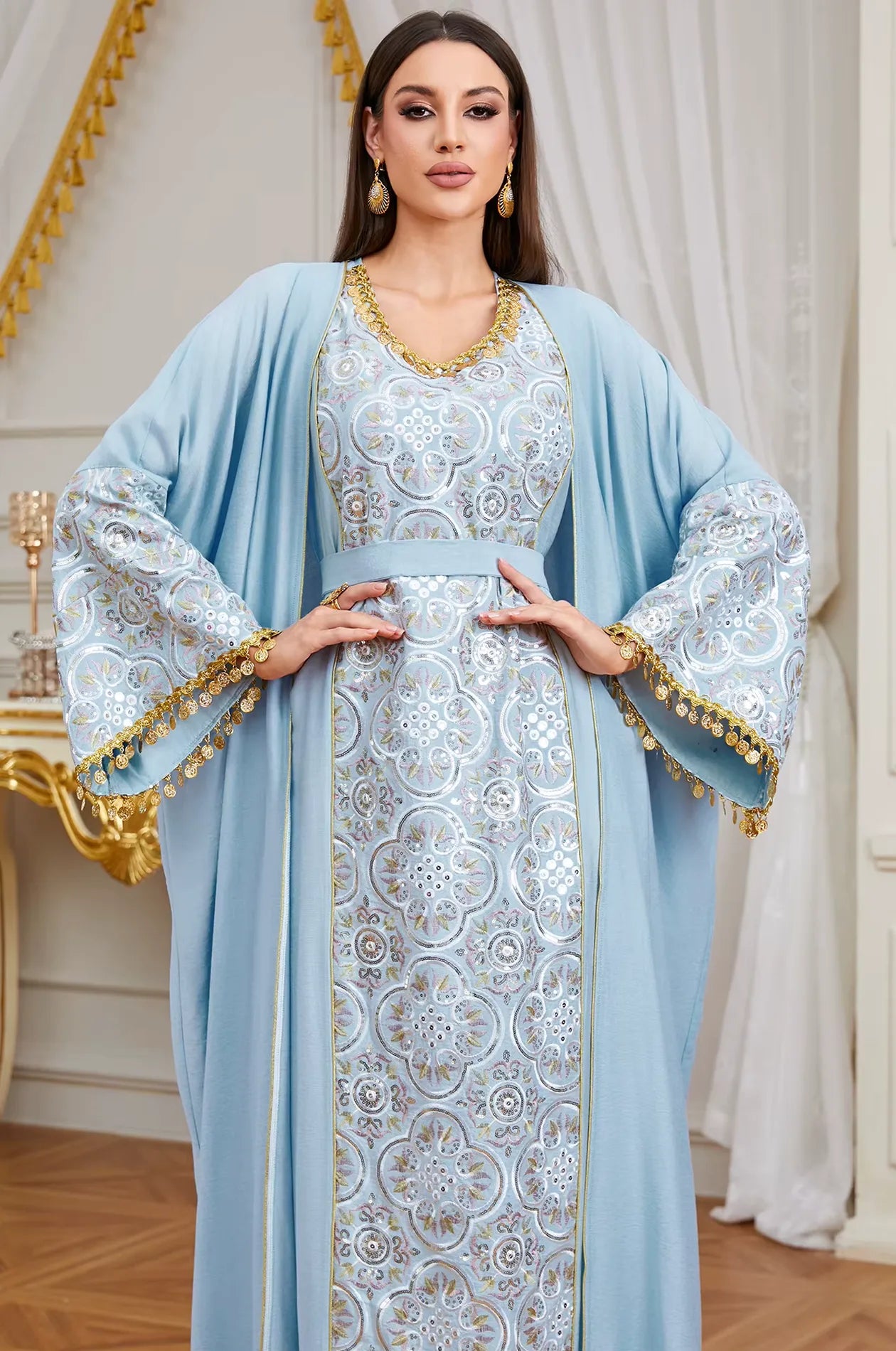 Close-up of the intricate gold and silver embroidery on the neckline of the sky blue Novae crepe kaftan.