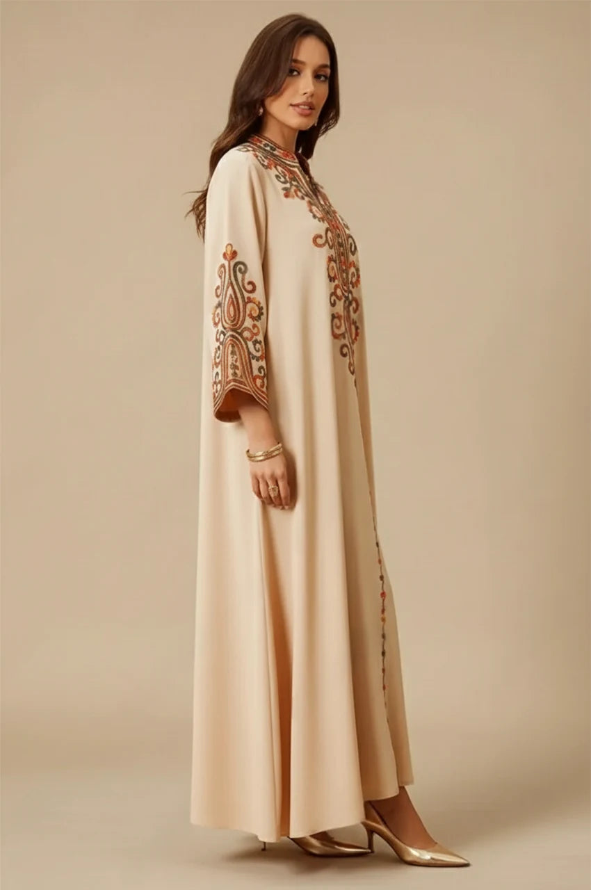 Side view of Soraya beige modern Moroccan kaftan showcasing detailed sleeve embroidery and fluid drape