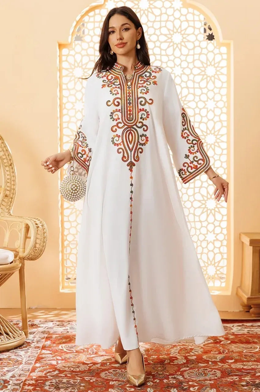 Elegant pose in Soraya white modern Moroccan kaftan with embroidered details and gold heels