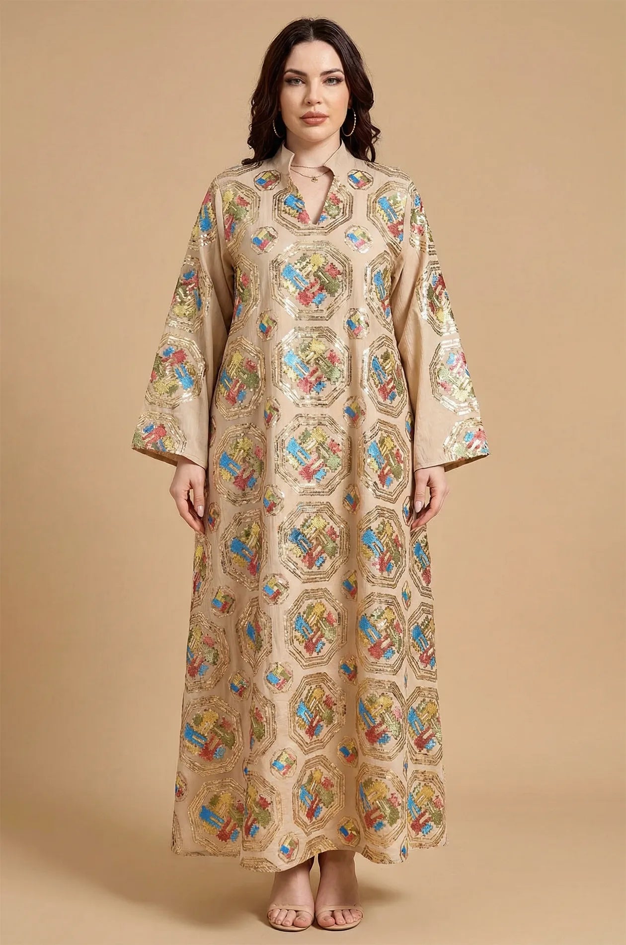 Front studio portrait of the Sorin beige mandarin collar kaftan showcasing the symmetrical geometric embroidery.