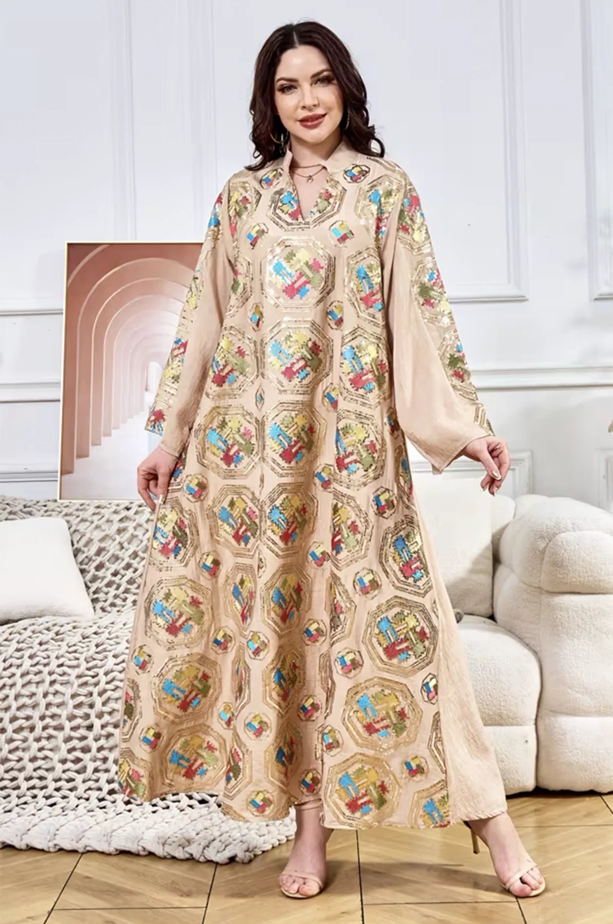 Full-length lifestyle view of the beige Sorin kaftan by Naylara, highlighting the elegant movement of the fabric.