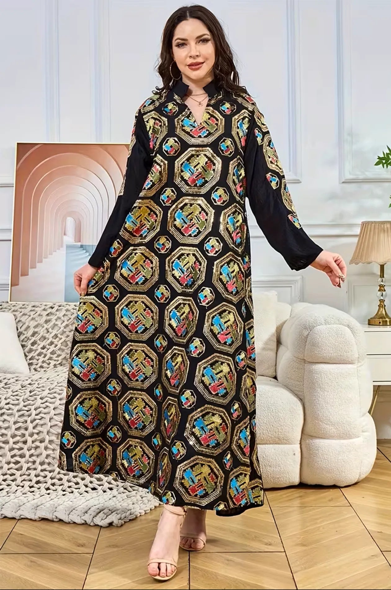 Elegant lifestyle shot of the black Sorin kaftan with a mandarin collar and intricate sequin detailing in a luxury setting.