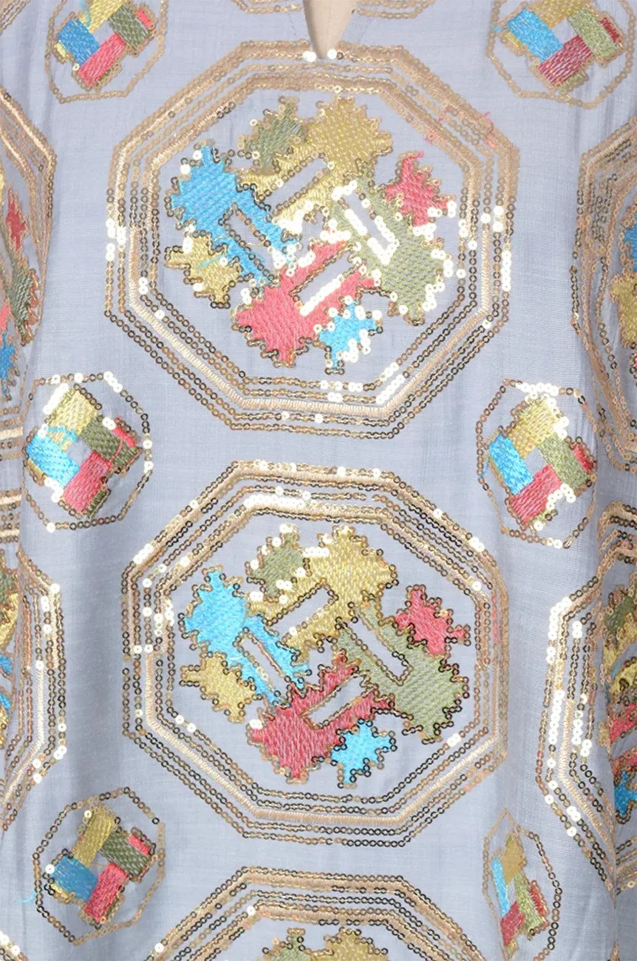 Close-up of the intricate gold sequin and geometric octagonal embroidery on the Sorin light blue kaftan.