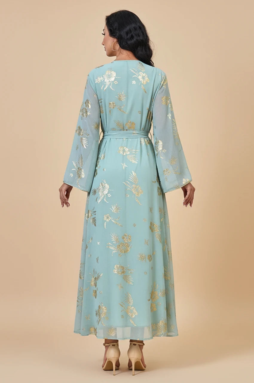 Studio back view of the Malika Aqua Gold dress showing the self-tie belt and gold foil pattern.