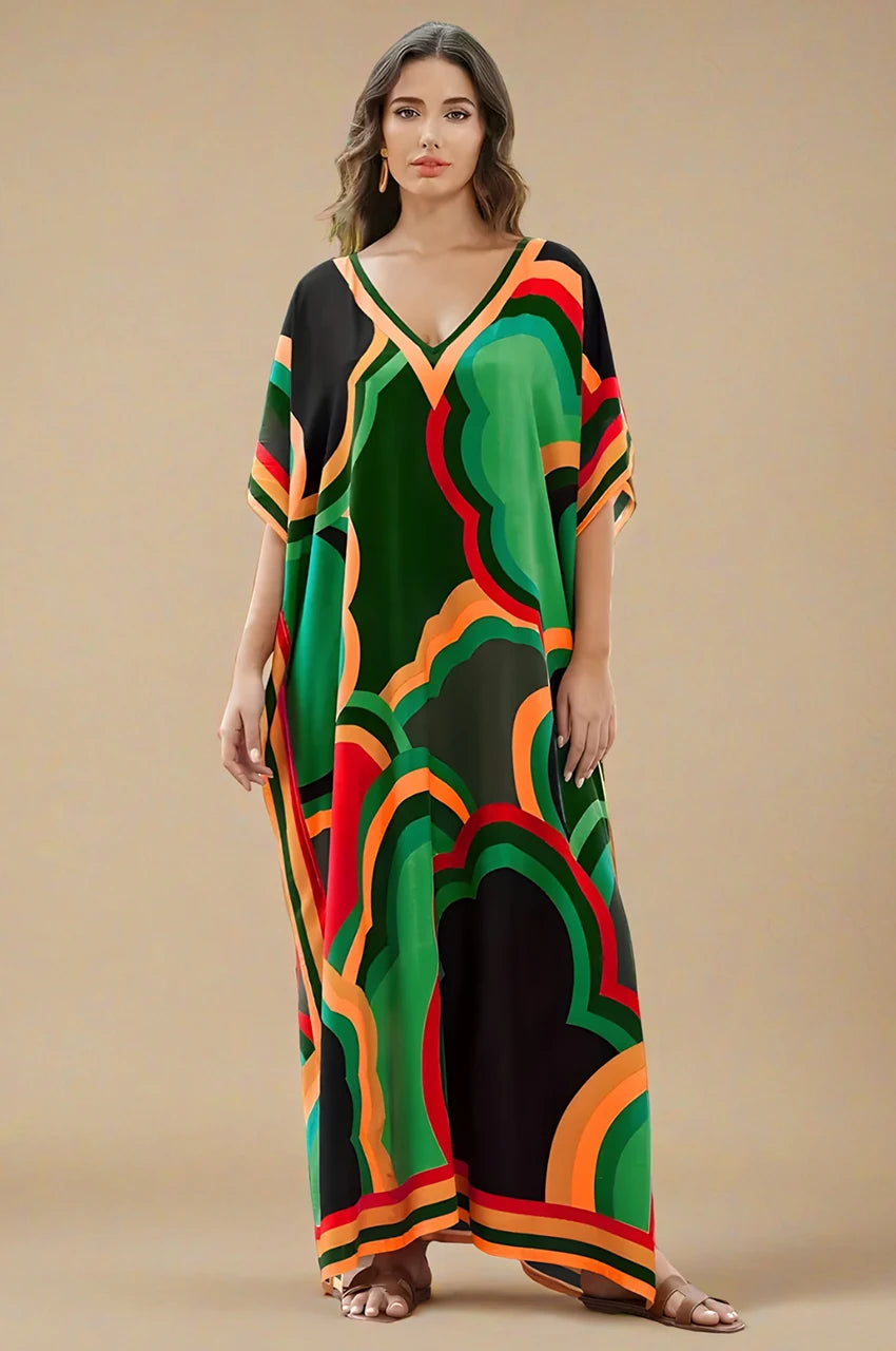 Studio shot of green boho kaftan maxi dress with vibrant geometric print