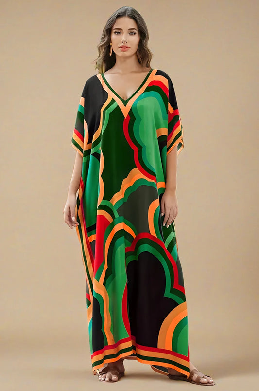 Studio shot of green boho kaftan maxi dress with vibrant geometric print