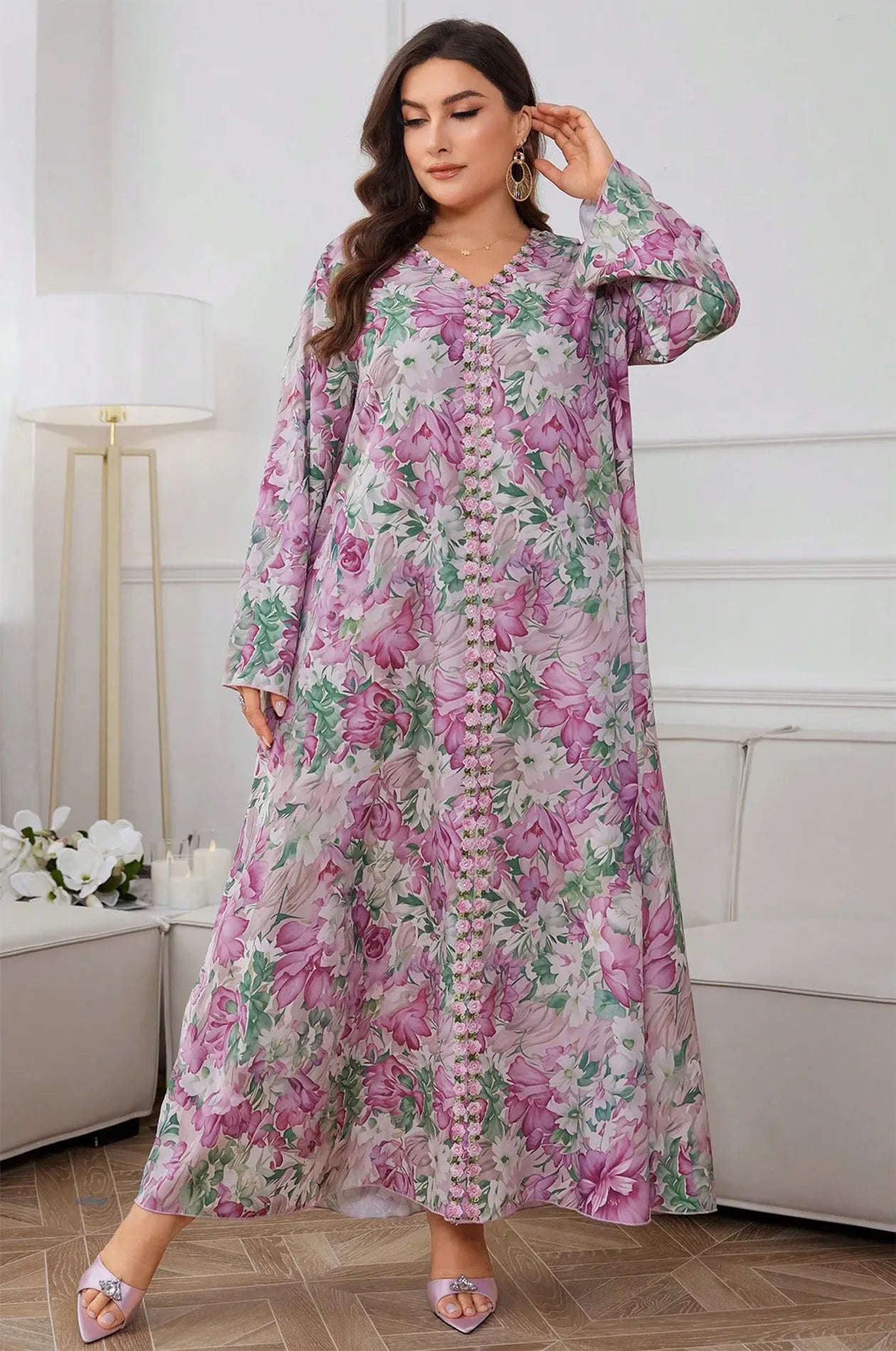 Full-length front view of a woman wearing the Suri light pink floral kaftan with beaded trim.