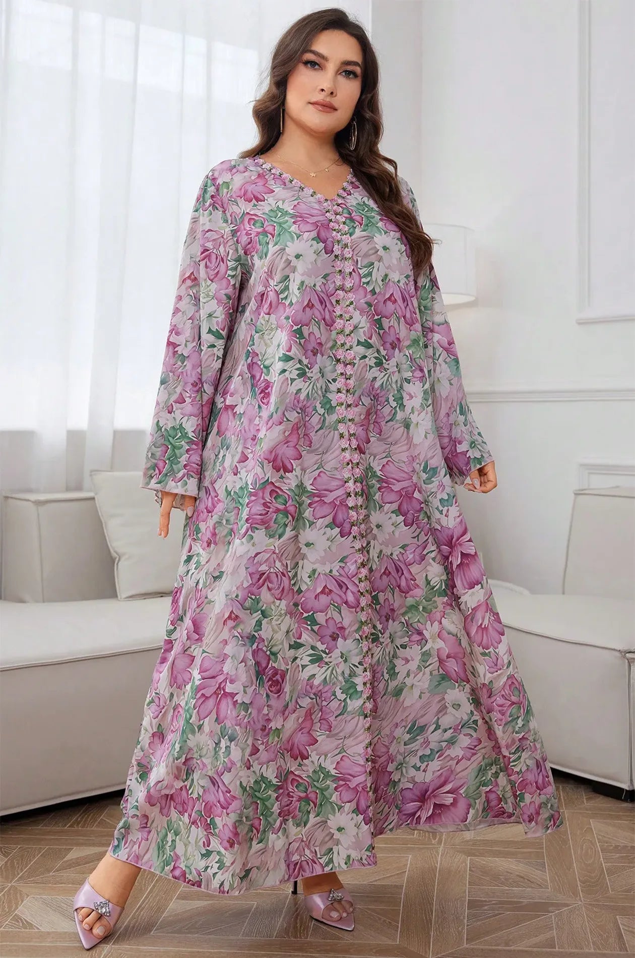 Dynamic pose of the Suri light pink kaftan highlighting the lightweight printed fabric.