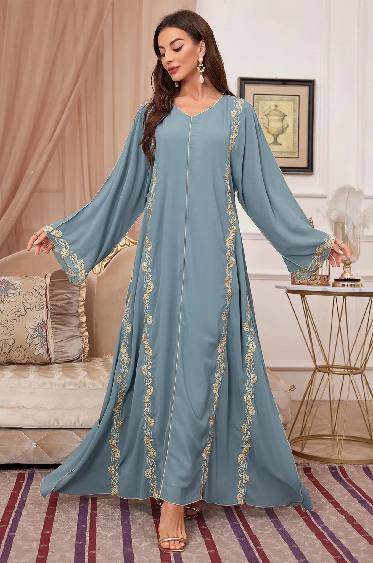 Full-length shot of the Tahra luxury blue and gold oriental dress.