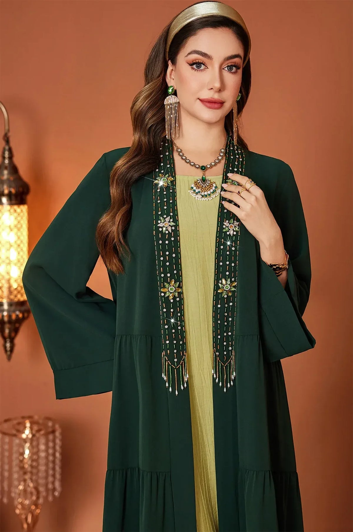 Close-up of the hand-beaded embroidery on the Thais dark green kaftan dress.