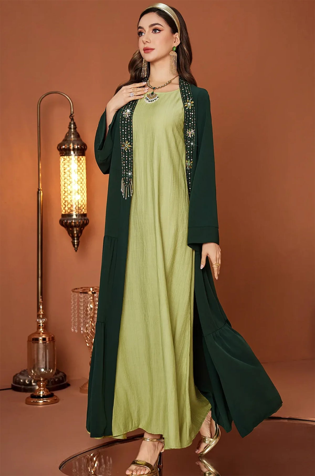 Full body shot of the Thais kaftan in a warm luxury interior setting.