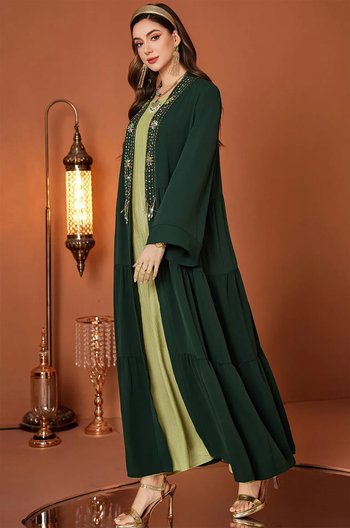 Walking pose showing the fluid movement of the tiered kaftan layers.
