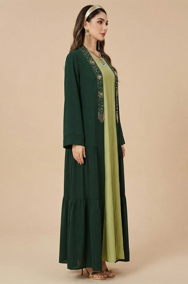 Side profile of the embellished dark green kaftan with lime inner dress.