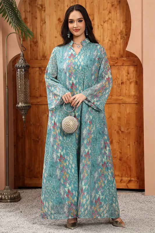 Tyrah light blue geometric print kaftan styled with a pearl clutch for a sophisticated evening look.