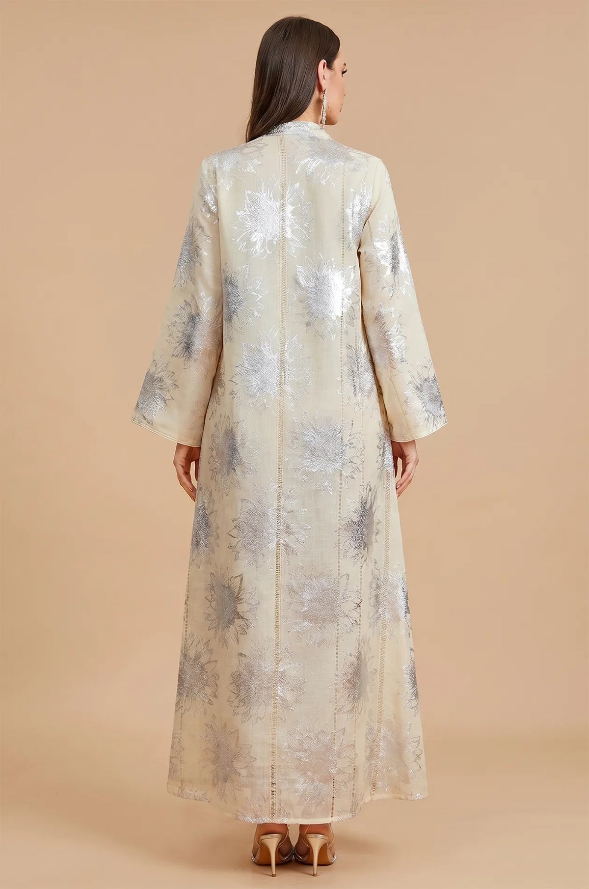 Back view of the Veris white and silver kaftan showing metallic floral patterns.