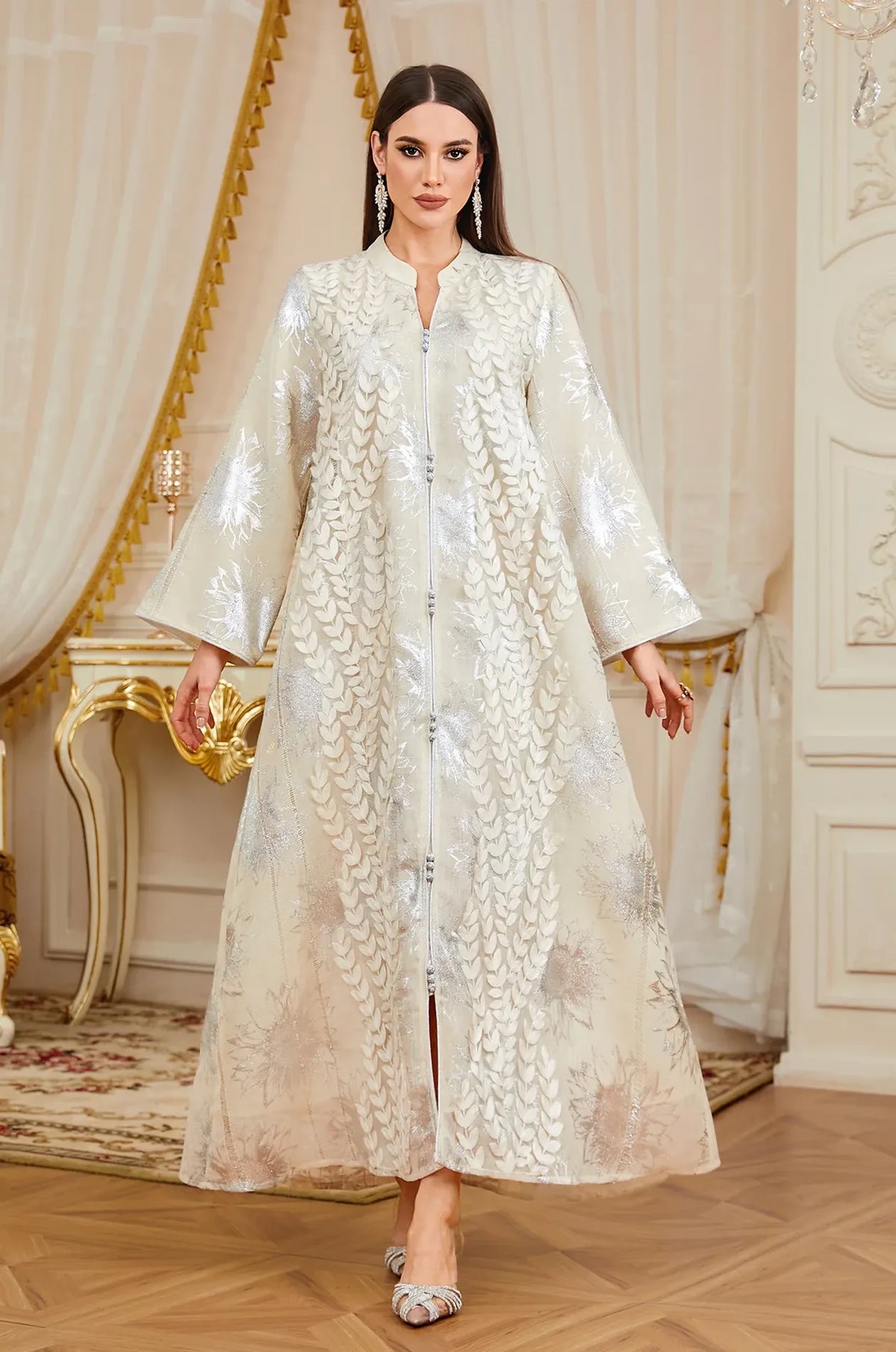 Close-up of the intricate silver embroidery and buttons on the Veris white kaftan.