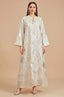 Full front view of Veris white Moroccan kaftan with silver sunburst embroidery.