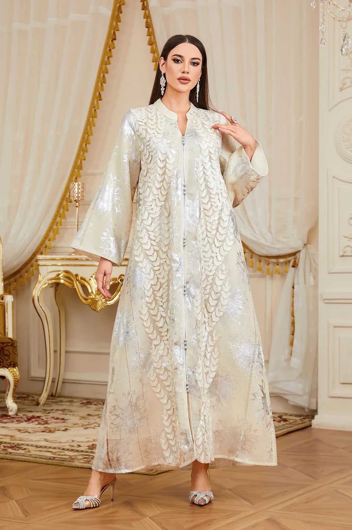 Luxury lifestyle shot of a model wearing the Veris white Moroccan kaftan in an ornate room.