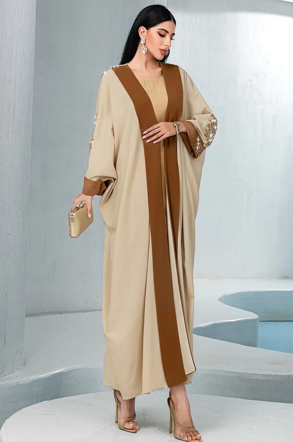Vetta Khaki kaftan styled with a luxury gold clutch for a wedding look.