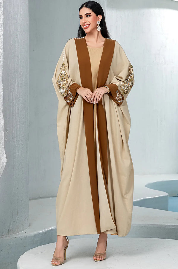 Model wearing the Vetta Khaki formal kaftan standing against a white pillar.