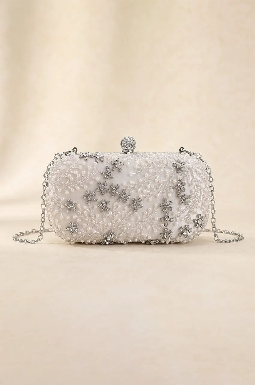 Front view of white oval hard-shell clutch featuring intricate pearl and crystal floral beading, perfect for bridal or formal Kaftan attire.