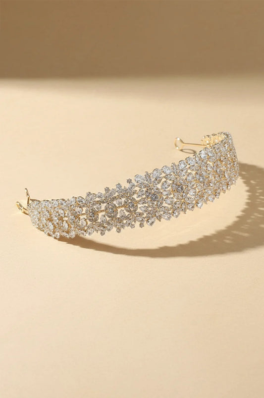 Isolated view of the Wide Gold-Tone Floral Headband on a cream background.