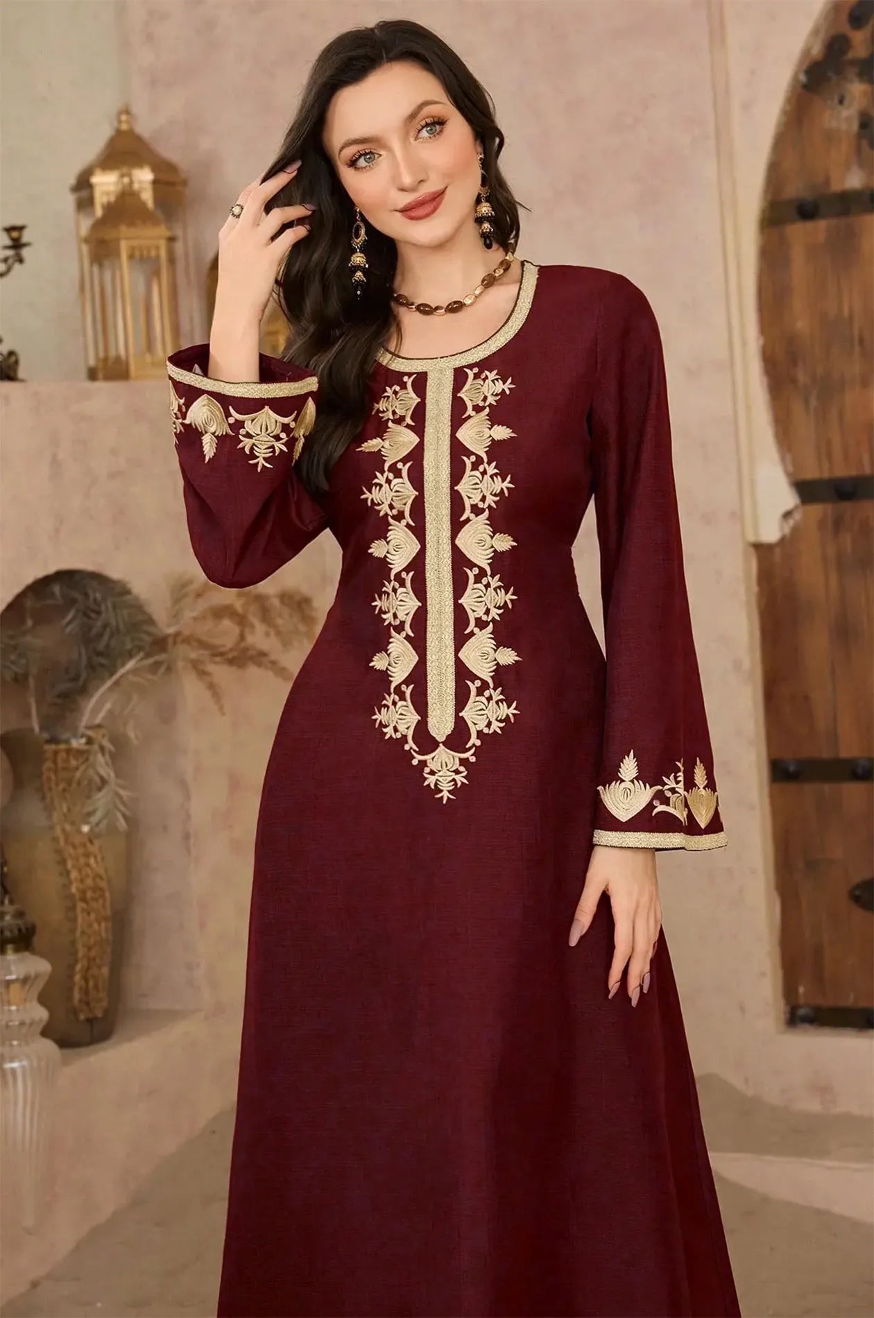 Close-up of gold floral embroidery on the wine kaftan bodice