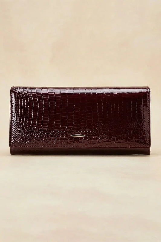 Front view of the wine red crocodile embossed patent long wallet with silver logo accent.