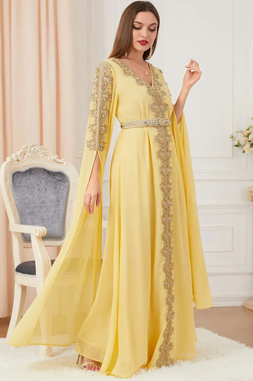 Yellow Moroccan-style kaftan with gold trim and open sleeves, side view