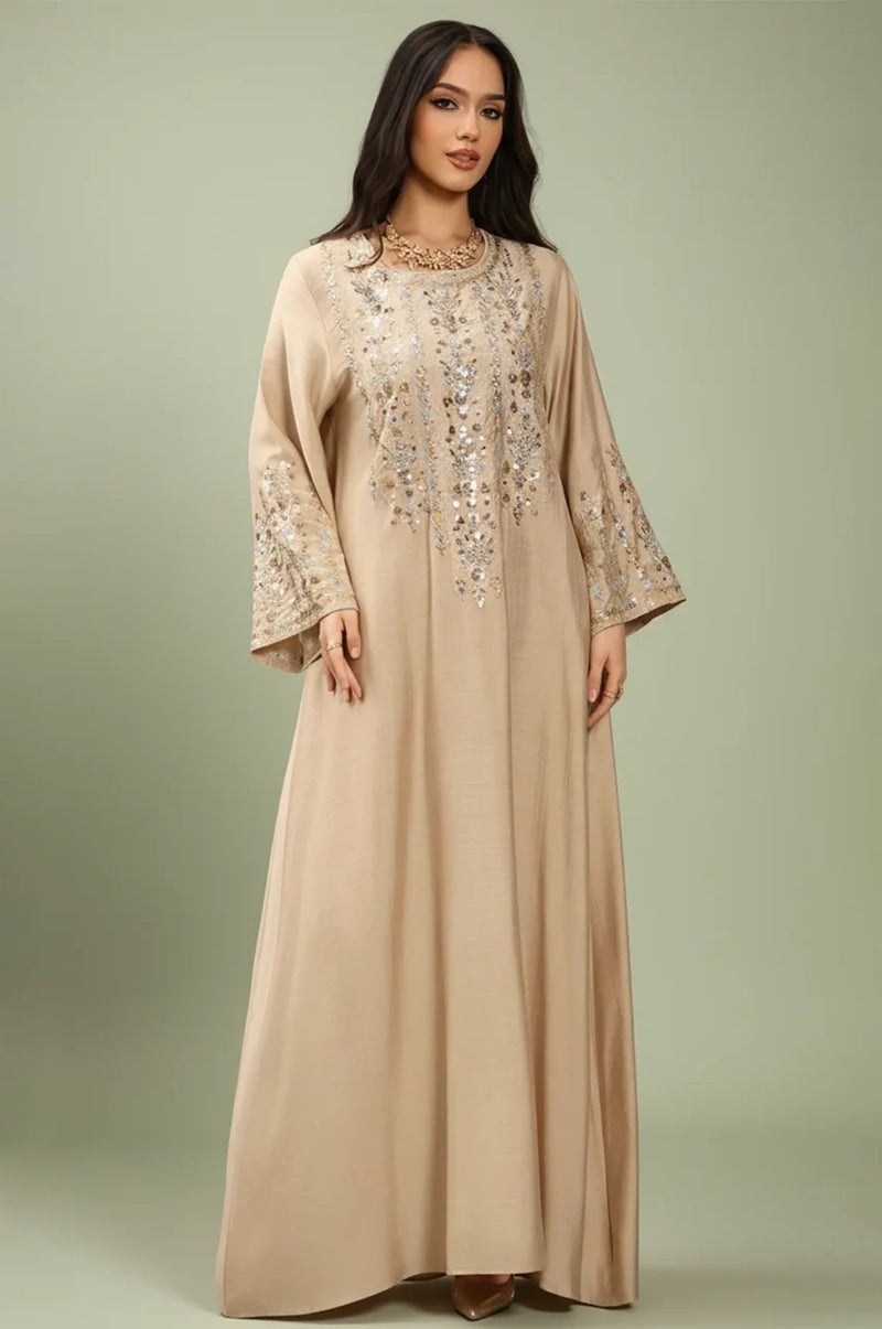 Full front view of the Zahia beige Saudi kaftan with gold artisan embroidery.