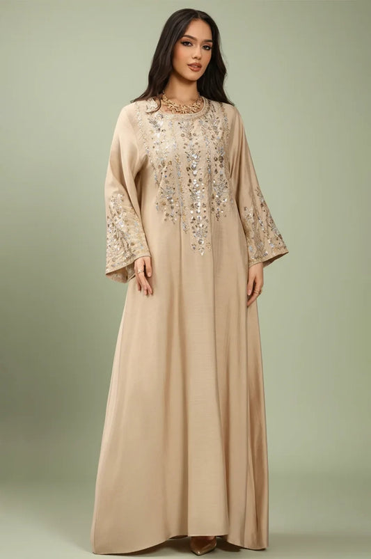 Full front view of the Zahia beige Saudi kaftan with gold artisan embroidery.