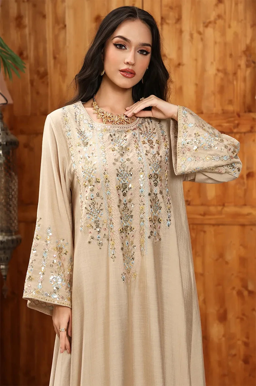 Detailed view of the Sfifa embroidery and sequin patterns on the Zahia neckline.