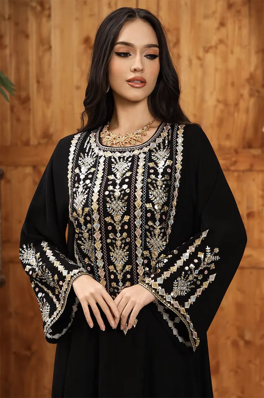 Close-up of the silver and gold artisan embroidery on the Zahia black kaftan bodice.