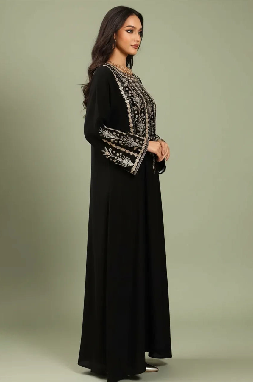 Side profile of the Zahia black Saudi kaftan highlighting flared bell sleeves and intricate silver embroidery.